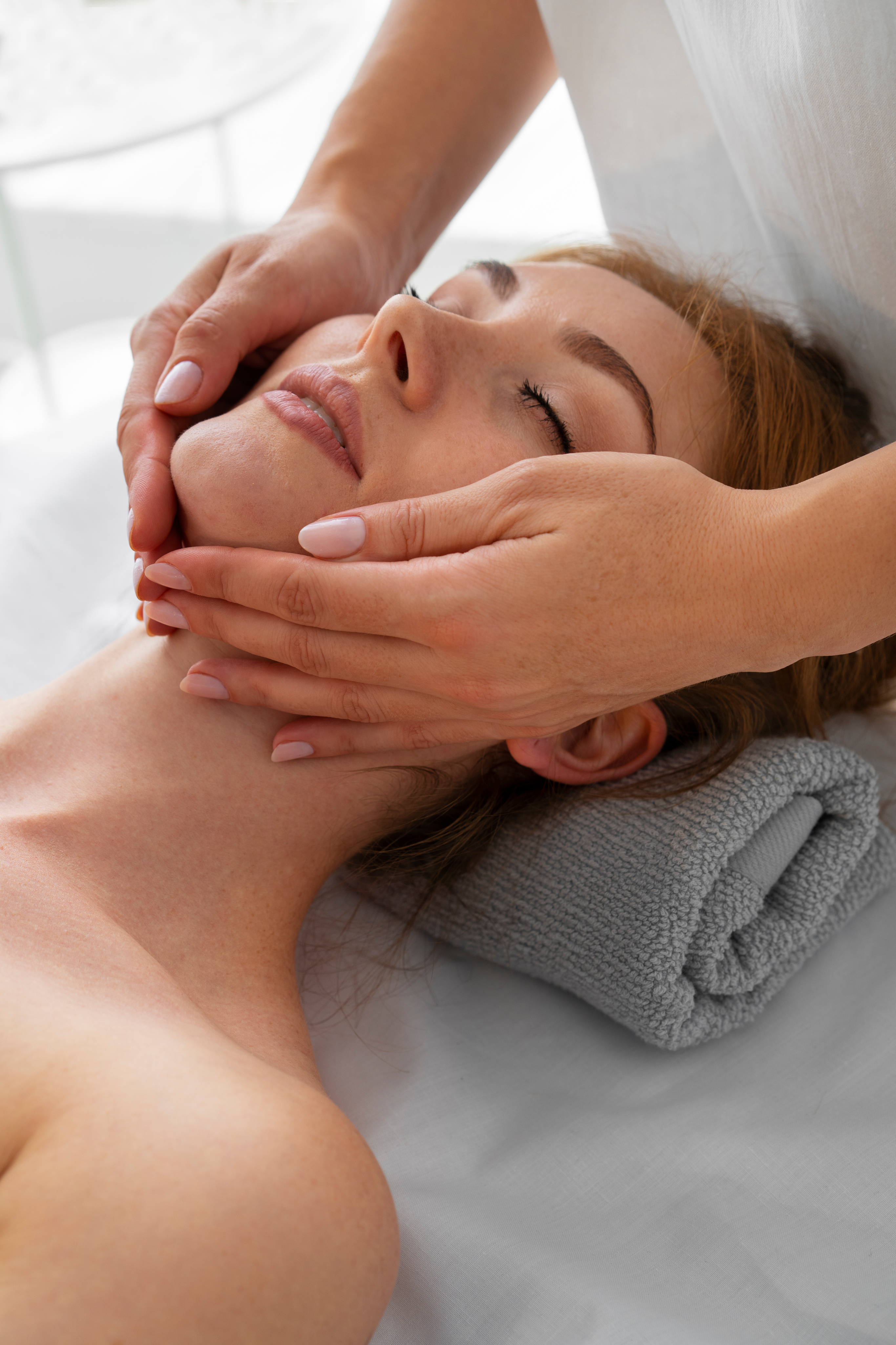 Woman receiving a relaxing facial massage